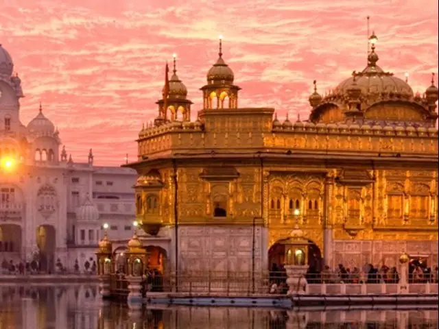 The Golden Temple at Amritsar reflected in its pool at dusk