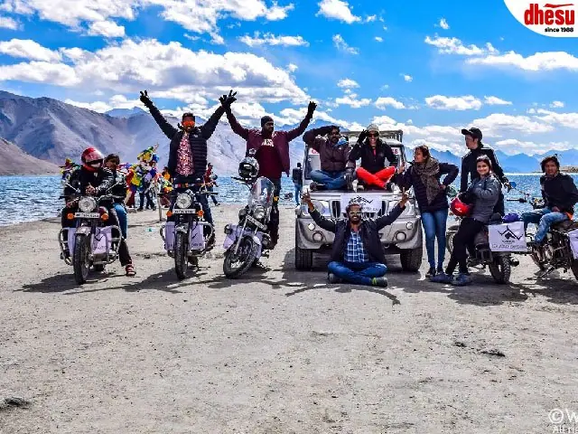 A tour group celebrating together at the end of a mountain run