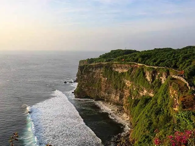 A green clifftop headland dropping to the sea below