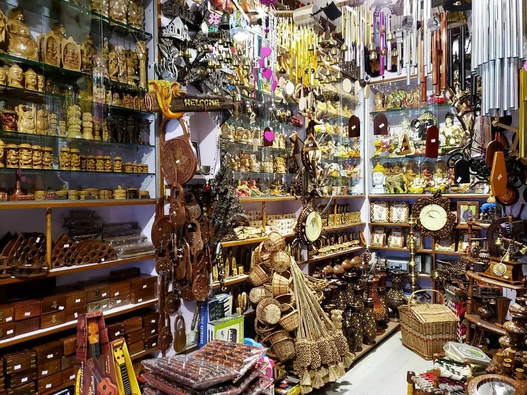 The crowded interior of a souvenir and handicraft shop packed with goods